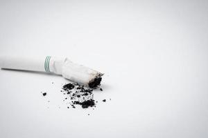 Cigarette butt with ash on a white background. Free space for text photo