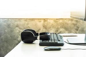 Headphones with desktop computer on the desk. photo