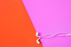 Earphones on colorful background. Free space for text photo