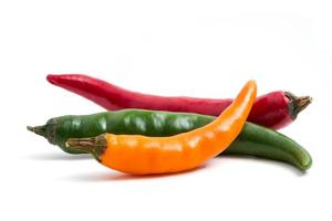 Colorful mix of chili pappers on white background. photo