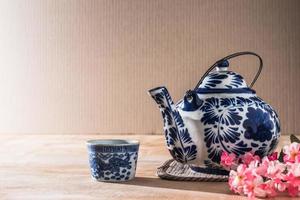 Tea pot ceramic chinese style on the wooden table. photo