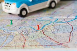 Toy car and push pin on the map. Travelling concept. Shallow depth of field. photo