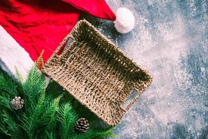 Empty basket with christmas decoration on gray grunge background. Free space for text photo