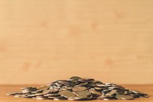 Pile of coins on a wooden table. Financial Concept. Selective focus. Free space for text photo