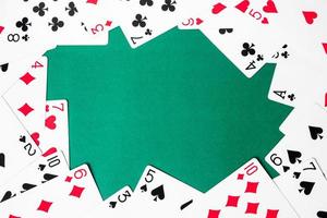Playing cards on green background. Free space for text photo