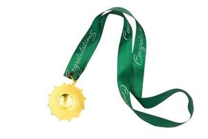 Gold medal with green ribbon on white background photo