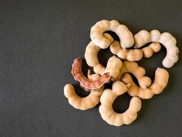 Sweet tamarind on black background photo