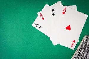 Playing cards, Four aces on green background. Free space for text photo