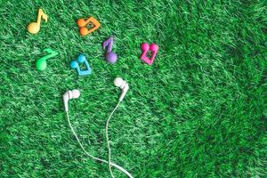 Top view of earphones on green grass background. photo