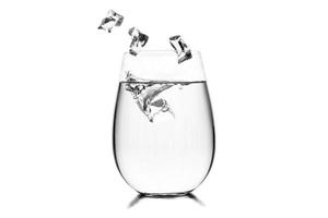 Glass of water with ice cubes on white background. photo