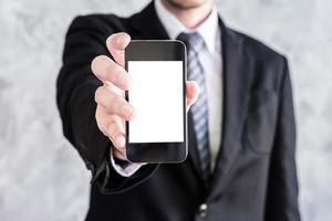 Close up of businessman holding smart phone on grunge background. photo