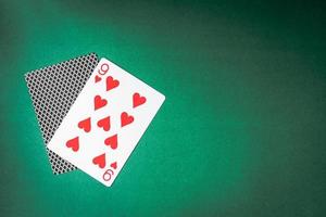 Playing card and back designs on green background. Free space for text photo