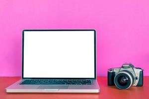 Modern laptop with blank screen, camera on colorful background. photo