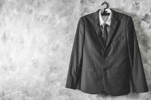 Gray suit and tie and white shirt on grunge background. Free space for text photo