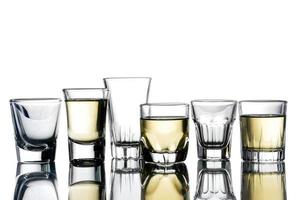 Collage of glasses with alcohol on a white background. photo