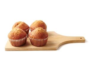 Banana cupcakes on a wooden tray, white background photo