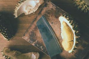 King of fruits, Durian with knife on wooden background. photo