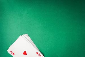 Playing cards on green background. Free space for text photo