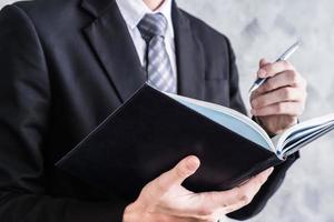 Close up of businessman checking documents on grunge background. photo