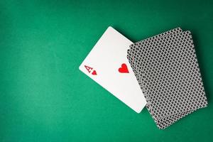 Heart ace with playing cards on green background. Free space for text photo