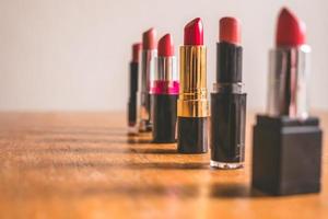 Colorful lipsticks on the wooden table. Makeup and Beauty concept. Selective focus photo