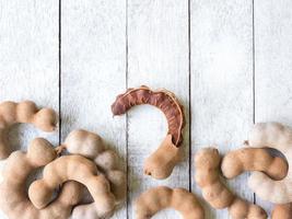 Sweet tamarind on wooden background photo