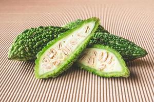 Bitter melon or bitter gourd on wooden background. photo