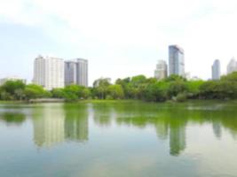 Building and pond in public park blur background of Illustration,Abstract Blurred photo