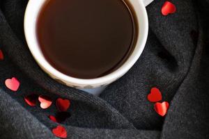 Cozy soft gray scarf with a cup of coffee. Morning. Valentine's day photo