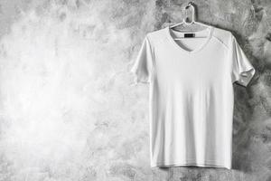 Blank white T-shirt on grunge background. Free space for text photo