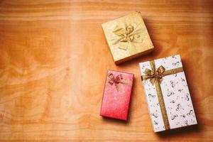 Top view of gift boxes on the wooden table. Free space for text photo