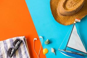 Top view of beach accessories on colorful background. photo