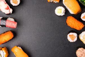 Top view of Sushi set on black background, Japanese food. Free space for text photo