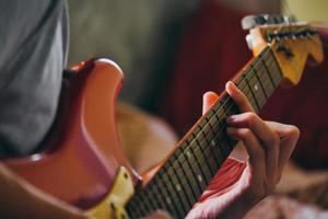 Close up of male hands playing electric guitar. Selective focus photo