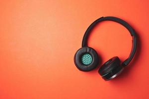 Modern headphones on a orange background. Free space for text photo