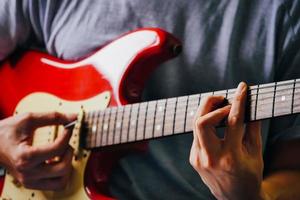 Close up of male hands playing electric guitar. Selective focus photo