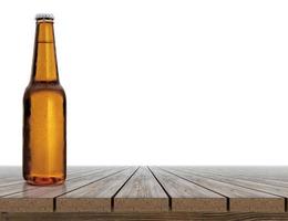 Beer bottle with water drops on wooden table photo