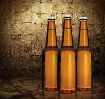 Close up of three beer bottles. Cold refreshment photo