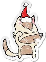 distressed sticker cartoon of a wolf pouting wearing santa hat vector