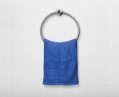 Blue hand towel hanging on hanger in toilet bathroom photo