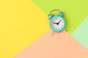 Minimalism flat lay top view. Alarm clock photo