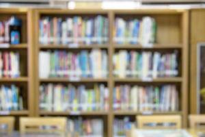 shelf with books in the library blurred background photo