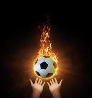 soccer ball ball. on black background with smoke, yellow orange red white colored back lights photo