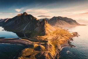 Spectacular Mount Eystrahorn in the Krossasnesfjall mountain range with sunlight shine in the morning on coastline in summer at East of Iceland photo