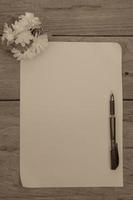 una hoja de papel con un bolígrafo sobre un escritorio de oficina de madera, efecto de filtro. foto