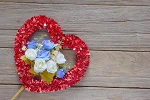 Tinsel heart  decoration on wood background photo