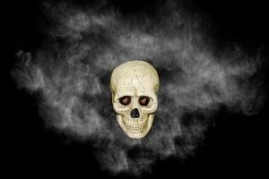 skull with white smoke on black background photo