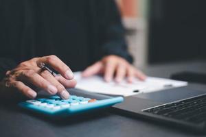 The auditor is analyzing his home documents, balance sheet management concept. form validation budget management and management of meeting reports, tax calculations photo