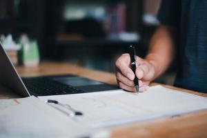 The auditor is analyzing his home documents, balance sheet management concept. form validation budget management and management of meeting reports photo