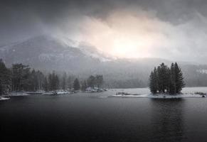 Sunrise over a beautiful mountain lake scene in Tahoe National Forest in Northern California.